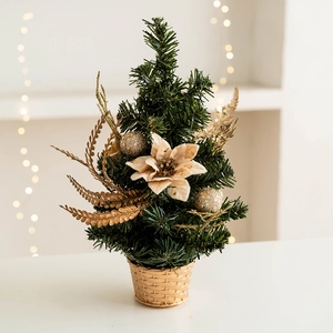 Miniature Nordic Christmas tree with gold ornaments and cream flower in gold pot