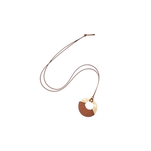 Vintage geometric necklace featuring hammered gold metal and dark wood pendant on cord