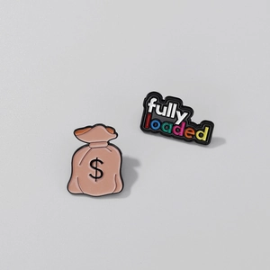 Macro detail of enamel pin set featuring a money bag and colorful fully loaded text