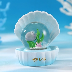 Marine crystal ball ornament with turtle and seashell base featuring gold Love lettering