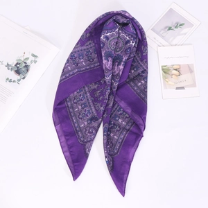 Detail of purple paisley print silk scarf displayed with Kinfolk magazine backdrop