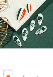 Close-up of St. Patrick's Day press-on nails with green shamrock and heart designs