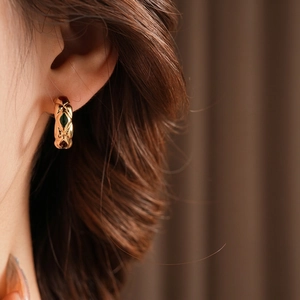 Vintage gold hoop earrings with rhombus relief pattern and red and green oval gemstones