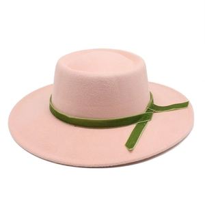 Detail of pink wool felt hat featuring a luxury olive green velvet decorative ribbon band