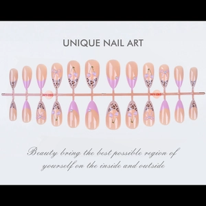 Detailed look at almond press-on nails with leopard print and cherry bow accents