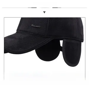 Detail of black winter trapper hat featuring textured fabric and ear protection