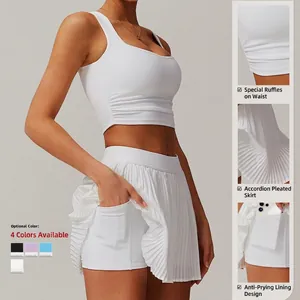 Women's white yoga set featuring a pleated skirt with built-in pockets and slim fit tank top