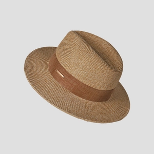 Detail of hand-woven straw hat texture with brown ribbon and gold metal buckle