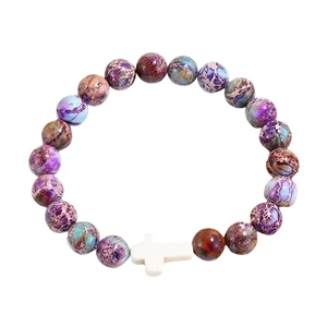 Handmade purple natural stone beaded bracelet featuring a white cross pendant on white background