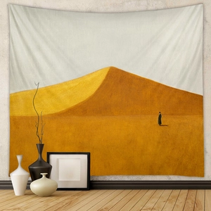 Detail of bohemian tapestry featuring minimalist golden sand dunes and a black silhouette