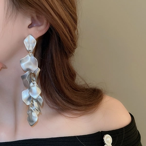 Detailed close-up of matte silver petal drop earrings with elegant long tassel design