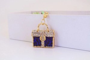 Detail of golden crystal handbag keychain with blue leopard print and rhinestones