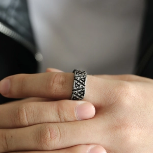 Detail showing the vintage titanium steel ring worn on hand with punk triangle patterns