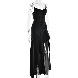 Detail of black evening gown featuring side ruching and ruffled slit on the hemline
