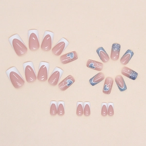 French tip press-on nails with blue glitter hearts and white minimalist design
