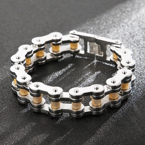 Detail of silver and gold-sand industrial chain link bracelet for men in stainless steel
