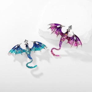 Dragon brooch with colorful enamel and sparkling rhinestones on a white stone base