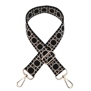 Adjustable black and beige geometric patterned canvas shoulder strap with gold metal hooks