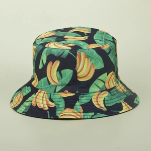 Close-up of tropical banana and leaf print on navy blue cotton canvas bucket hat
