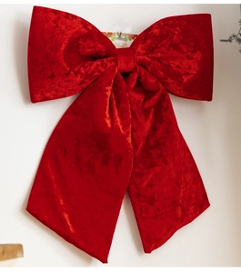 Close-up of a large red velvet decorative bow for Christmas trees and festive ornaments