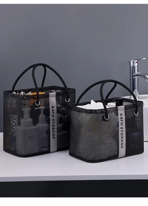 Detail of black mesh shower bags in large and medium sizes on a white bathroom vanity