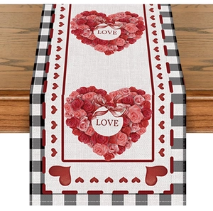 Macro detail of red rose love hearts and black buffalo plaid on linen holiday table runner