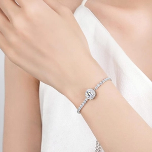 Elegant 925 sterling silver halo bracelet with round cut main stone and paved diamonds