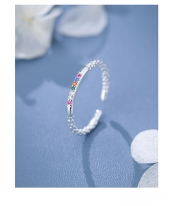 Macro detail of S925 sterling silver ring with colorful zircons and flower petals