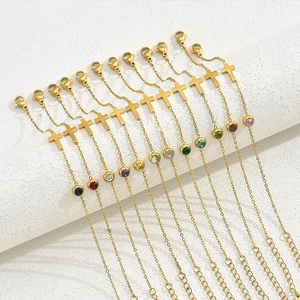 Set of 12 gold cross bracelets featuring colorful gemstones and adjustable chain