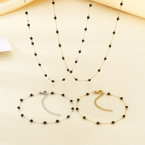 Detail of four-leaf clover necklaces and bracelets with black beads and lobster clasps