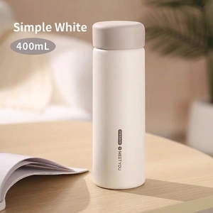Minimalist matte white stainless steel insulated 400ml water bottle on a wooden desk