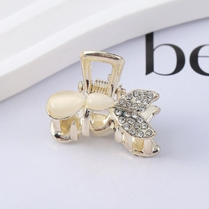 Elegant gold metal butterfly hair claw with opal stones and sparkling rhinestones