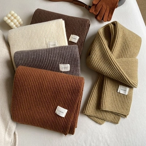 Thick knit scarves in brown, beige, and grey with a soft ribbed texture for winter warmth