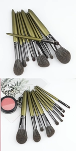 Detail of 9-piece green makeup brush set including eyeshadow and foundation tools