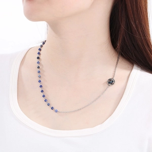 Minimalist stainless steel necklace with blue beads and compass pendant on model