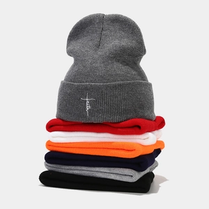 Multi-color knit beanies with Faith embroidery stacked vertically for street fashion