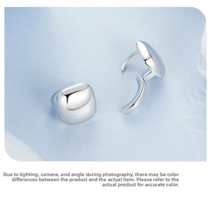 Macro shot of minimalist square silver hoop earrings with high polish finish