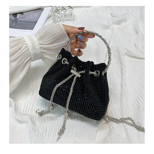 Detail of black rhinestone bucket bag with silver ring handle and chain tassel drawstrings