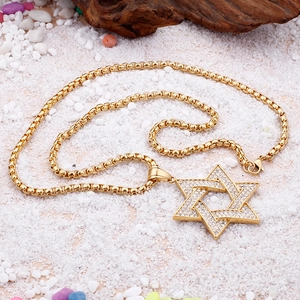Detailed close-up of a gold star pendant with clear crystals on a square pearl chain