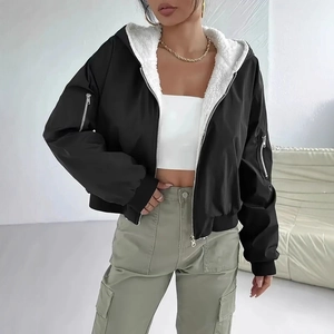 Detail of a black hooded jacket with white fleece lining and functional sleeve zippers
