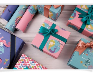 Detail view of Princess OF the SEA mermaid gift wrapping paper set with satin ribbons