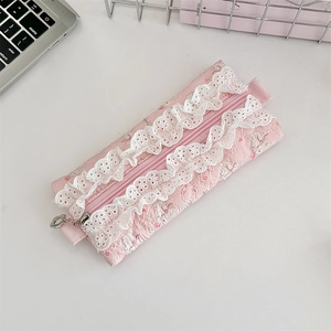 Close-up of pink quilted cotton pencil case with floral rabbit print and lace trim
