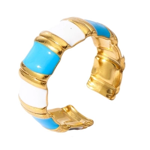 Detailed macro of 18k gold plated C-shape ring with blue and white enamel bamboo texture