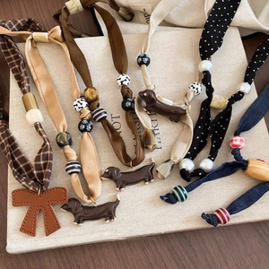 Puppy and cherry pendant necklace with wooden beads and fabric bow in vintage warm tones