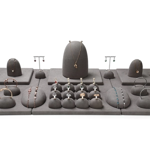 Luxury gray velvet jewelry display set for necklaces, rings, and earrings on white background