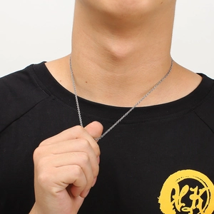 Silver chain necklace on neck showing drape and polished metallic finish link detail