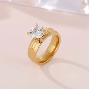 Detail of 6mm gold hammered band ring with large four-prong square clear gemstone