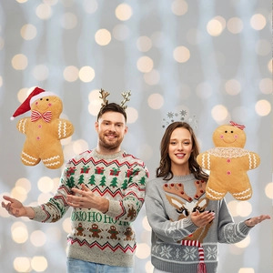 Detail of Christmas gingerbread man plush toy and cozy holiday knitwear with LED background