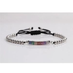 Macro shot of silver beaded bracelet featuring rainbow zircon stones and black braided cord