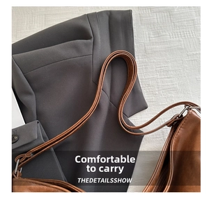 Detail showing comfortable double thin handles of a vintage dark brown PU tote bag